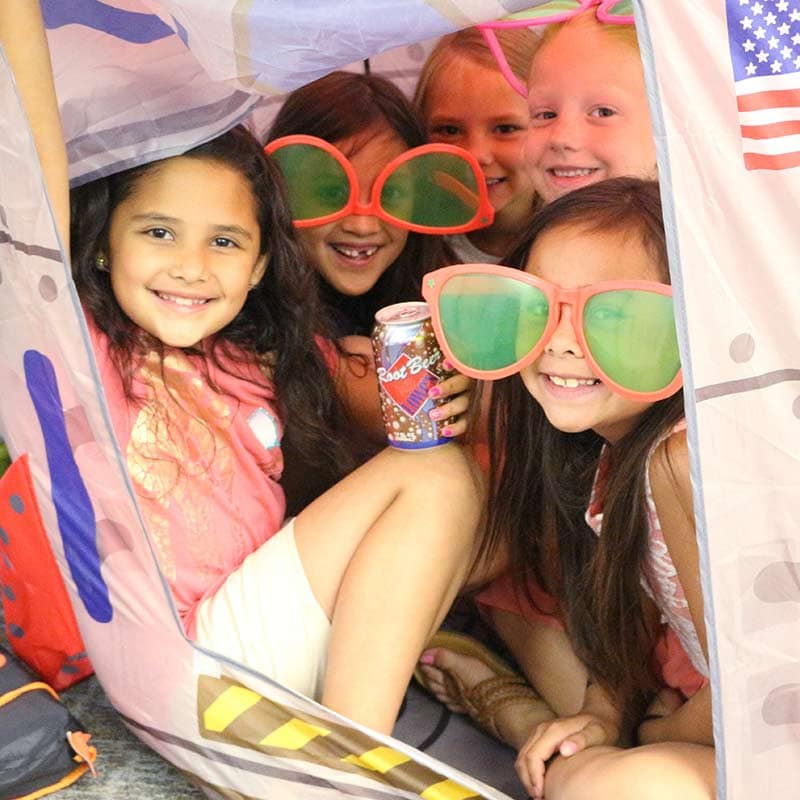 Girls playing in a tent