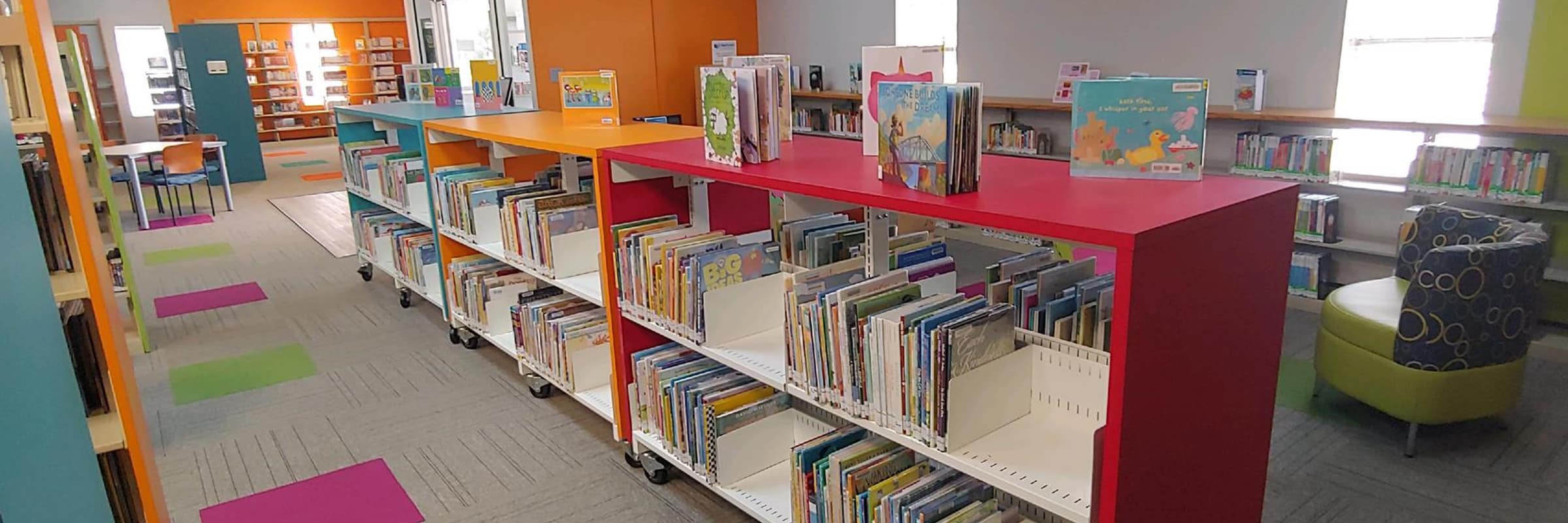 Bright bookcases in children's library area.