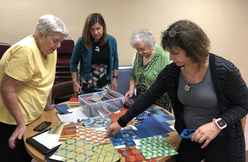 committee reviewing fabric and paint swatches
